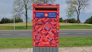 A Canada Post mailbox shown along a streetside